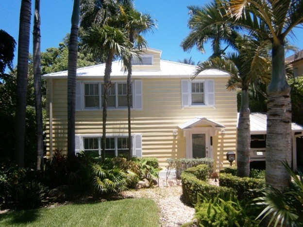 Hurricane Impact Resistant Windows and Doors in West Palm Beach, FL Coastal home with impact windows and glass entry, featuring Hurricane impact windows and doors in West Palm Beach, FL.